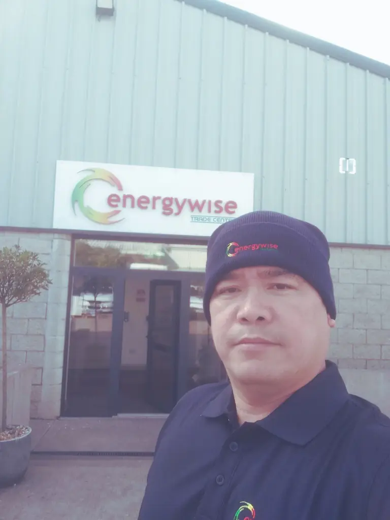 Man wearing a branded cap and polo outside a workplace